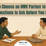 Carbon project developer questioning an MRV vendor across a table before signing a field data contract