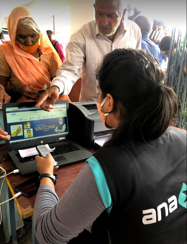 Anaxee Digital Runner helping a villager register on CoWIN in rural India