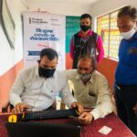 Project Swaraksha free COVID-19 vaccination camp with an Anaxee Digital Runner assisting a villager