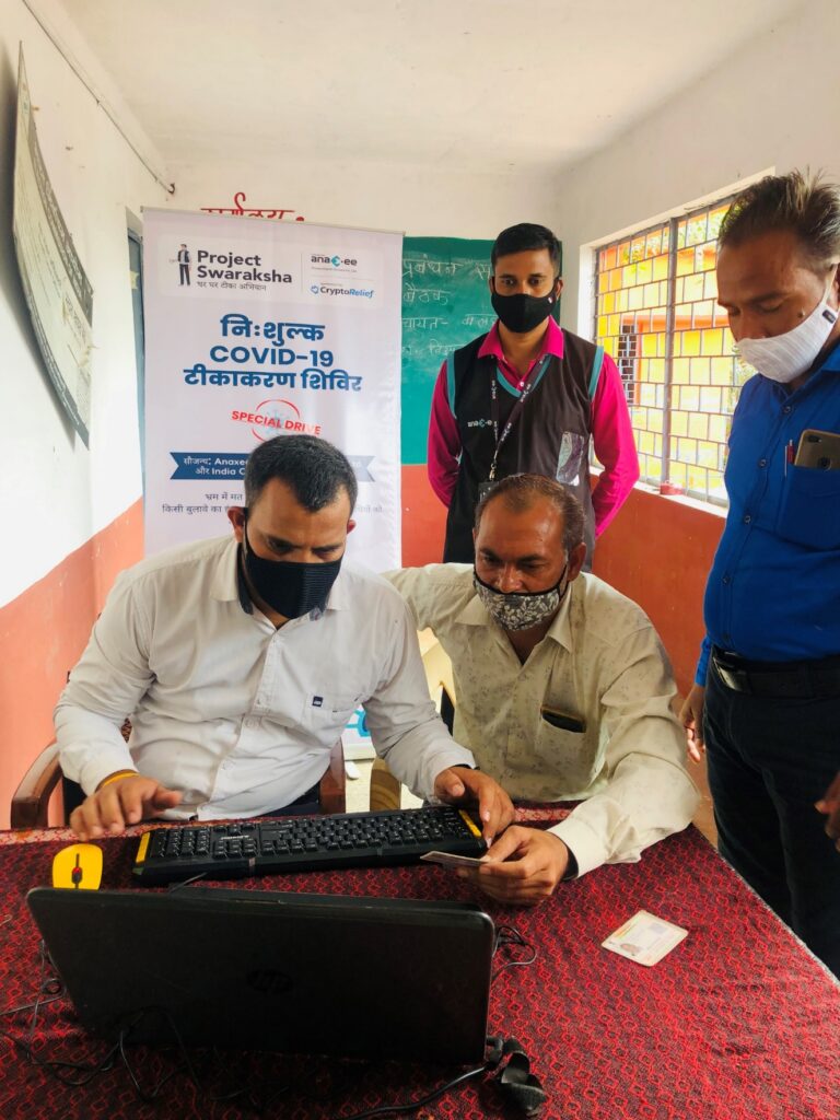 Project Swaraksha free COVID-19 vaccination camp with an Anaxee Digital Runner assisting a villager